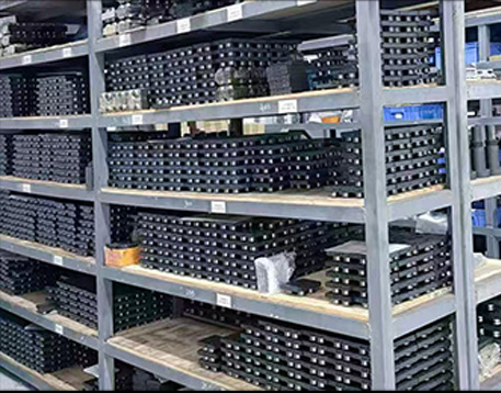 Automation parts warehouse with stocked circular guide rails and conveyor system components
