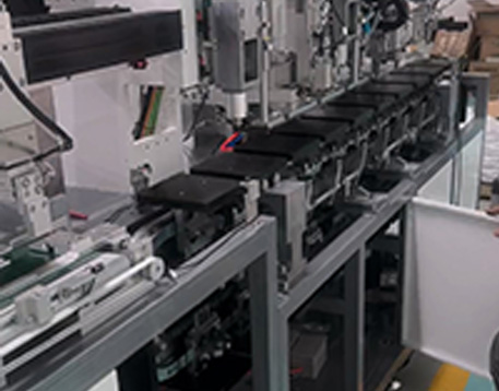 Engineers commissioning a customized circular guide rail conveyor system